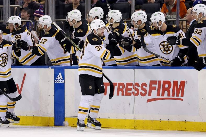 Jan 19, 2023; New York, New York, USA; Boston Bruins center Patrice Bergeron (37) celebrates his goal against the New York Rangers with teammates during the second period at Madison Square Garden. Mandatory Credit: Brad Penner-USA TODAY Sports