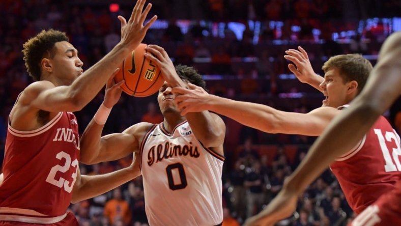 Jan 19, 2023; Champaign, Illinois, USA;  Indiana Hoosiers forward Trayce Jackson-Davis (23) and Miller Kopp (12) defend against  Illinois Fighting Illini guard Terrence Shannon Jr. (0) during the first half at State Farm Center. Mandatory Credit: Ron Johnson-USA TODAY Sports