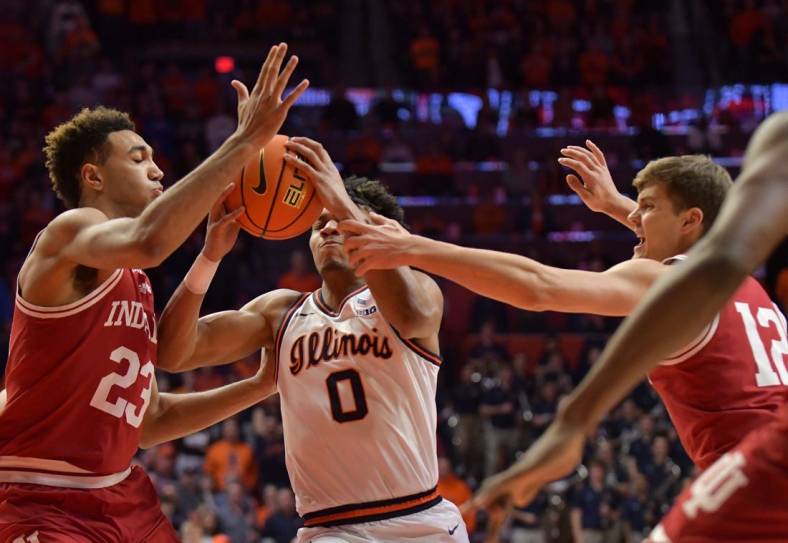 Jan 19, 2023; Champaign, Illinois, USA;  Indiana Hoosiers forward Trayce Jackson-Davis (23) and Miller Kopp (12) defend against  Illinois Fighting Illini guard Terrence Shannon Jr. (0) during the first half at State Farm Center. Mandatory Credit: Ron Johnson-USA TODAY Sports