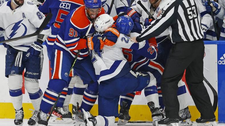 Jan 19, 2023; Edmonton, Alberta, CAN; Edmonton Oilers forward Evander Kane (91) and Tampa Bay Lightning defensemen Zach Bogosian (24) rough each other up during the first period at Rogers Place. Mandatory Credit: Perry Nelson-USA TODAY Sports