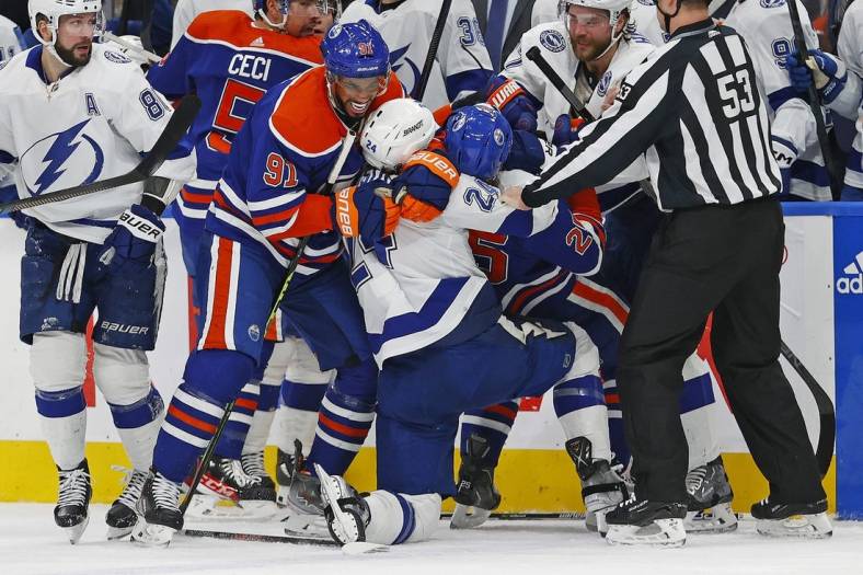 Jan 19, 2023; Edmonton, Alberta, CAN; Edmonton Oilers forward Evander Kane (91) and Tampa Bay Lightning defensemen Zach Bogosian (24) rough each other up during the first period at Rogers Place. Mandatory Credit: Perry Nelson-USA TODAY Sports