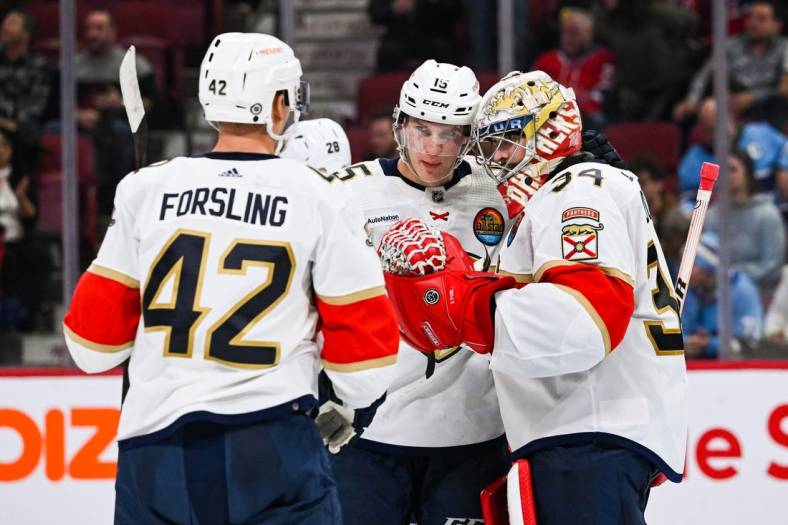 Jan 19, 2023; Montreal, Quebec, CAN; Florida Panthers goalie Alex Lyon (34) celebrates the win against the Montreal Canadiens with defenseman Gustav Forsling (42) and center Anton Lundell (15) after the third period at Bell Centre. Mandatory Credit: David Kirouac-USA TODAY Sports
