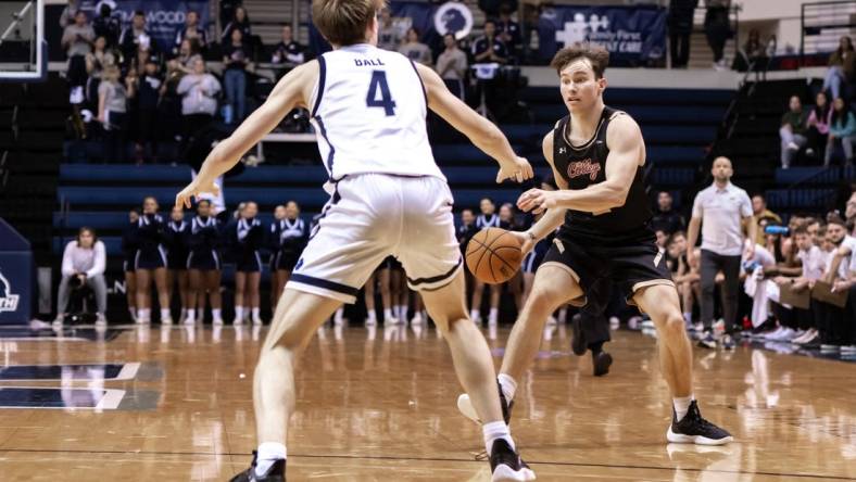 Jan 19, 2023; West Long Branch, New Jersey, USA; Charleston Cougars guard Reyne Smith (2) sets the play as Monmouth Hawks guard Andrew Ball (4) defends during the first half at OceanFirst Bank Center. Mandatory Credit: John Jones-USA TODAY Sports