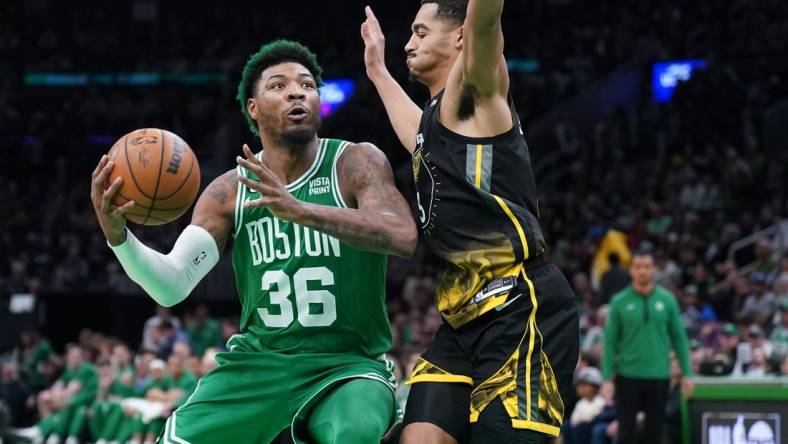 Jan 19, 2023; Boston, Massachusetts, USA; Boston Celtics guard Marcus Smart (36) drives the ball against Golden State Warriors guard Jordan Poole (3) in the second half at TD Garden. Mandatory Credit: David Butler II-USA TODAY Sports