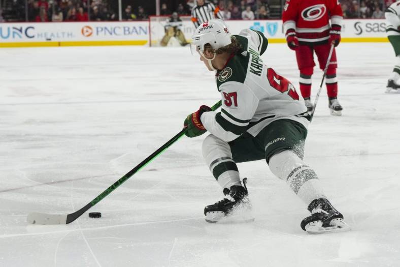 Jan 19, 2023; Raleigh, North Carolina, USA; Minnesota Wild left wing Kirill Kaprizov (97) skates with he puck against the Carolina Hurricanes during the second period at PNC Arena. Mandatory Credit: James Guillory-USA TODAY Sports