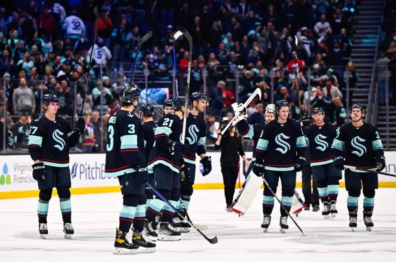 Jan 19, 2023; Seattle, Washington, USA; The Seattle Kraken celebrate after defeating the New Jersey Devils in overtime at Climate Pledge Arena. Seattle defeated New Jersey 4-3. Mandatory Credit: Steven Bisig-USA TODAY Sports