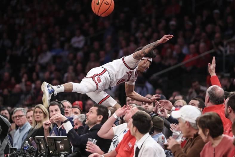 Jan 20, 2023; New York, New York, USA;  St. John's Red Storm guard Andre Curbelo (3) falls into the stands chasing a loose ball in the first half against the Villanova Wildcats at Madison Square Garden. Mandatory Credit: Wendell Cruz-USA TODAY Sports