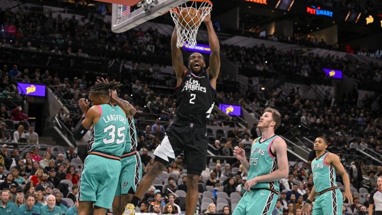 Jan 20, 2023; San Antonio, Texas, USA; LA Clippers forward Kawhi Leonard (2) dunks the ball past San Antonio Spurs guard Romeo Langford (35) and center Jakob Poeltl (25) during the first quarter at the AT&T Center. Mandatory Credit: Jerome Miron-USA TODAY Sports