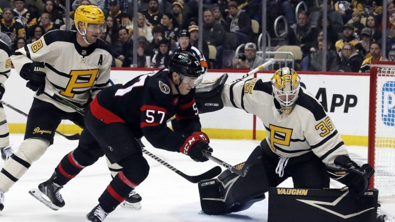 Jan 20, 2023; Pittsburgh, Pennsylvania, USA;  Pittsburgh Penguins goaltender Tristan Jarry (35) makes a save against Ottawa Senators center Shane Pinto (57) during the second period at PPG Paints Arena. Mandatory Credit: Charles LeClaire-USA TODAY Sports