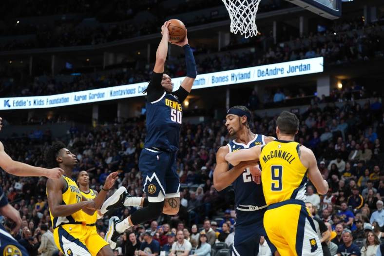 Jan 20, 2023; Denver, Colorado, USA; Denver Nuggets forward Aaron Gordon (50) finishes off a basket in the first quarter against the Indiana Pacers at Ball Arena. Mandatory Credit: Ron Chenoy-USA TODAY Sports