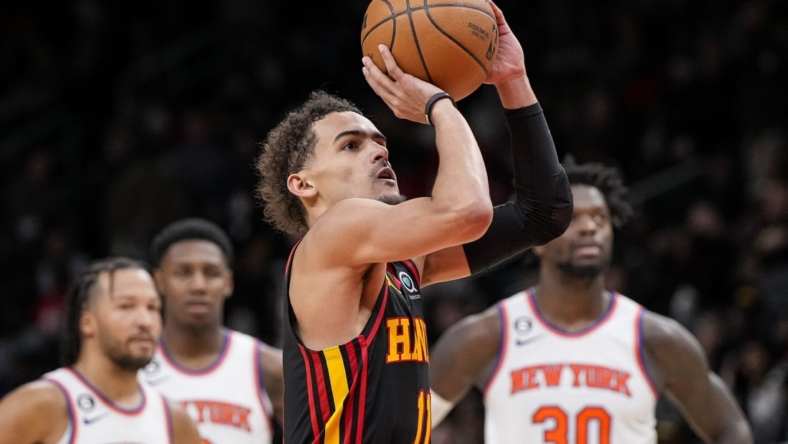 Jan 20, 2023; Atlanta, Georgia, USA; Atlanta Hawks guard Trae Young (11) shoots a foul shot watched by New York Knicks players after a technical foul call during the second half at State Farm Arena. Mandatory Credit: Dale Zanine-USA TODAY Sports