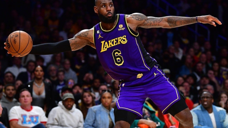January 20, 2023; Los Angeles, California, USA; Los Angeles Lakers forward LeBron James (6) plays to keeop the ball in bound against the Memphis Grizzlies during the second half at Crypto.com Arena. Mandatory Credit: Gary A. Vasquez-USA TODAY Sports
