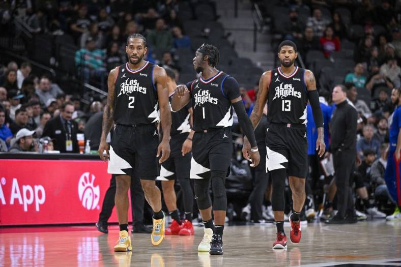 Jan 20, 2023; San Antonio, Texas, USA; LA Clippers forward Kawhi Leonard (2) and guard Reggie Jackson (1) and guard Paul George (13) walk back onto the court during the second half against the San Antonio Spurs at the AT&T Center. Mandatory Credit: Jerome Miron-USA TODAY Sports
