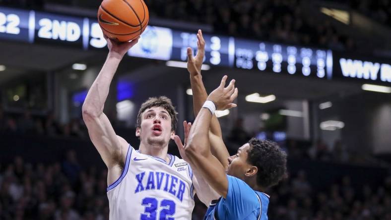 Jan 21, 2023; Cincinnati, Ohio, USA; Xavier Musketeers forward Zach Freemantle (32) shoots against Georgetown Hoyas guard Wayne Bristol Jr. (31) in the second half at Cintas Center. Mandatory Credit: Katie Stratman-USA TODAY Sports