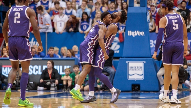 Jan 21, 2023; Lawrence, Kansas, USA; TCU Horned Frogs guard Mike Miles Jr. (1) hugs TCU Horned Frogs guard Shahada Wells (13) in reaction to a play during the second half against the Kansas Jayhawks at Allen Fieldhouse. Mandatory Credit: William Purnell-USA TODAY Sports