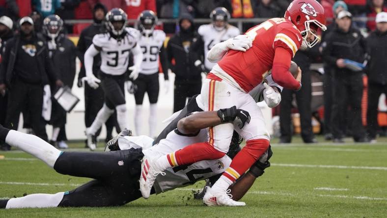 Jan 21, 2023; Kansas City, Missouri, USA; Kansas City Chiefs quarterback Patrick Mahomes (15) is brought down by Jacksonville Jaguars linebacker Travon Walker (44) during the first half in the AFC divisional round game at GEHA Field at Arrowhead Stadium. Mandatory Credit: Denny Medley-USA TODAY Sports