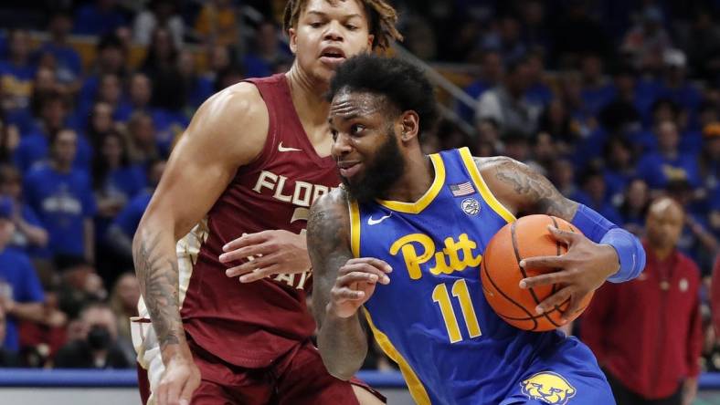 Jan 21, 2023; Pittsburgh, Pennsylvania, USA;  Pittsburgh Panthers guard Jamarius Burton (11) drives to the basket against Florida State Seminoles forward Cam Corhen (3) during the second half at the Petersen Events Center. The Seminoles won 71-64. Mandatory Credit: Charles LeClaire-USA TODAY Sports