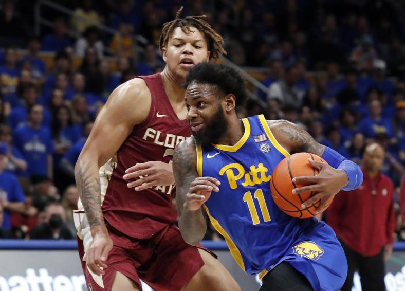 Jan 21, 2023; Pittsburgh, Pennsylvania, USA;  Pittsburgh Panthers guard Jamarius Burton (11) drives to the basket against Florida State Seminoles forward Cam Corhen (3) during the second half at the Petersen Events Center. The Seminoles won 71-64. Mandatory Credit: Charles LeClaire-USA TODAY Sports