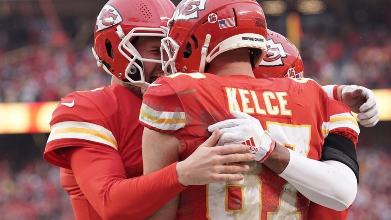 Jan 21, 2023; Kansas City, Missouri, USA; Kansas City Chiefs tight end Travis Kelce (87) celebrates his touchdown scored against the Jacksonville Jaguars with quarterback Chad Henne (4) during the first half in the AFC divisional round game at GEHA Field at Arrowhead Stadium. Mandatory Credit: Denny Medley-USA TODAY Sports