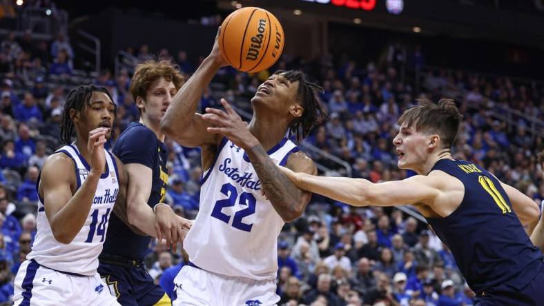 Jan 21, 2023; Newark, New Jersey, USA; Seton Hall Pirates forward Tae Davis (22) is fouled by Marquette Golden Eagles guard Tyler Kolek (11) in front of forward Ben Gold (21) and guard Dre Davis (14) during the second half at Prudential Center. Mandatory Credit: Vincent Carchietta-USA TODAY Sports