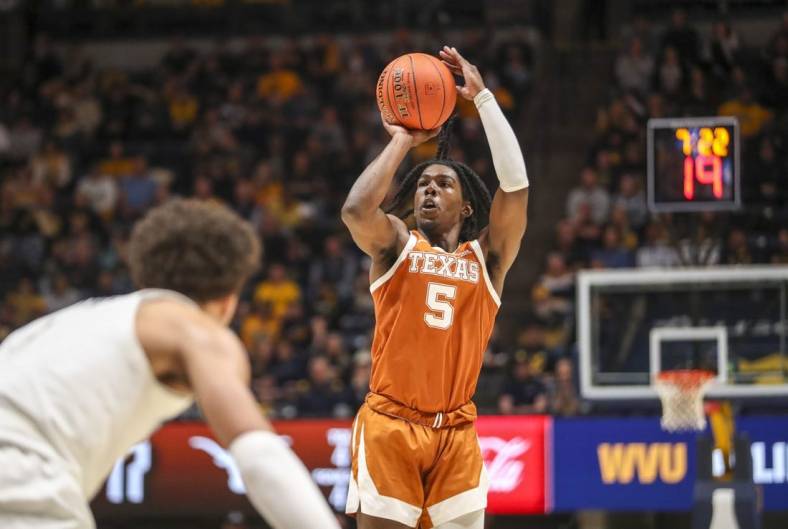 Jan 21, 2023; Morgantown, West Virginia, USA; Texas Longhorns guard Marcus Carr (5) shoots a three pointer during the first half against the West Virginia Mountaineers at WVU Coliseum. Mandatory Credit: Ben Queen-USA TODAY Sports