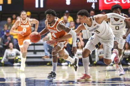 Jan 21, 2023; Morgantown, West Virginia, USA; Texas Longhorns guard Tyrese Hunter (4) steals a pass as West Virginia Mountaineers forward Tre Mitchell (3) defends during the first half at WVU Coliseum. Mandatory Credit: Ben Queen-USA TODAY Sports