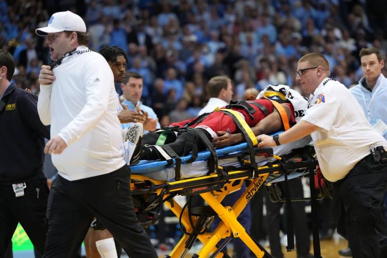 Jan 21, 2023; Chapel Hill, North Carolina, USA;  North Carolina State Wolfpack guard Terquavion Smith (0) is taken off the court on a stretcher after being injured in the second half at Dean E. Smith Center. Mandatory Credit: Bob Donnan-USA TODAY Sports
