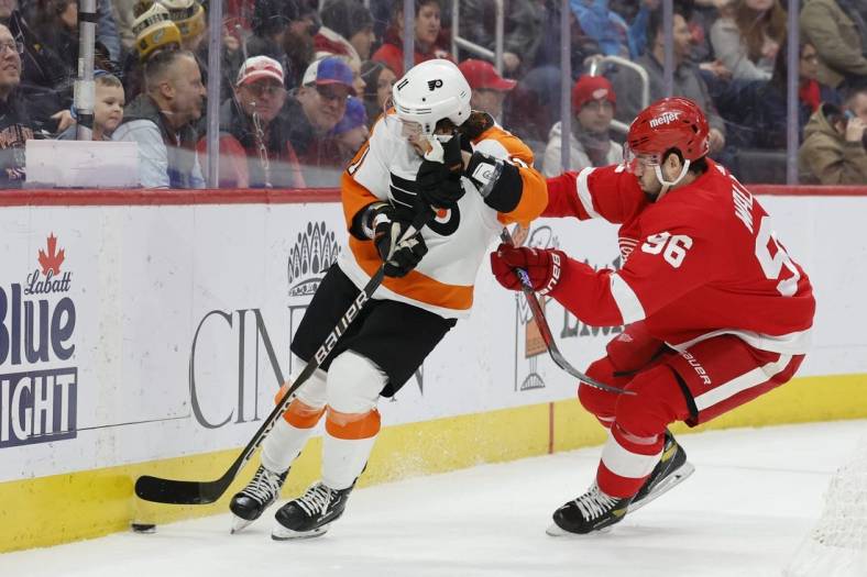 Jan 21, 2023; Detroit, Michigan, USA;  Philadelphia Flyers right wing Travis Konecny (11) skates with the puck chased by Detroit Red Wings defenseman Jake Walman (96) in the first period at Little Caesars Arena. Mandatory Credit: Rick Osentoski-USA TODAY Sports