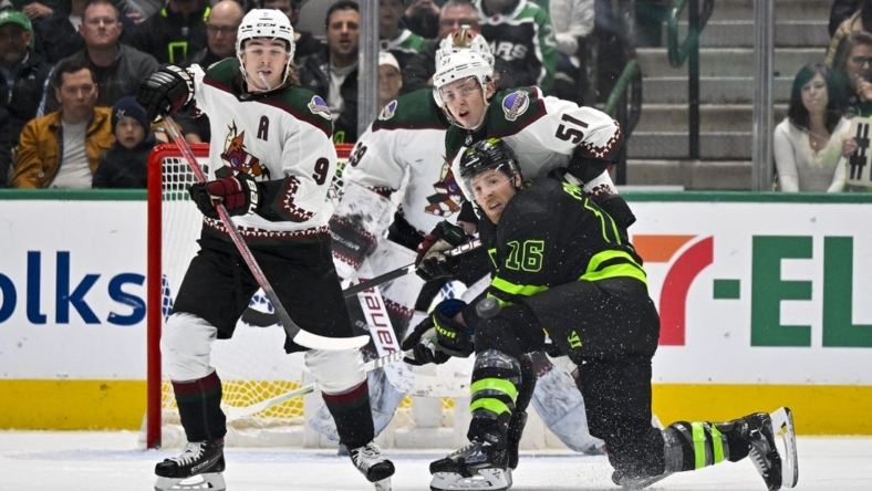 Jan 21, 2023; Dallas, Texas, USA; Arizona Coyotes right wing Clayton Keller (9) and defenseman Troy Stecher (51) and Dallas Stars center Joe Pavelski (16) look for the puck in the Coyotes zone during the first period at the American Airlines Center. Mandatory Credit: Jerome Miron-USA TODAY Sports