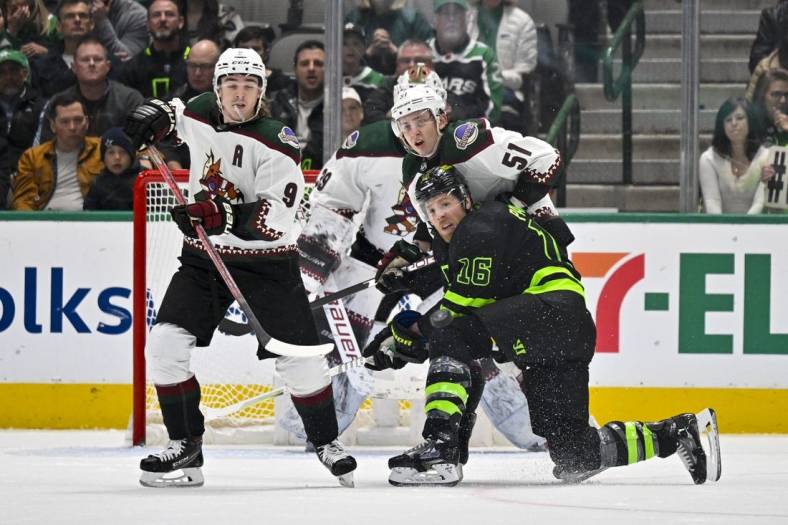 Jan 21, 2023; Dallas, Texas, USA; Arizona Coyotes right wing Clayton Keller (9) and defenseman Troy Stecher (51) and Dallas Stars center Joe Pavelski (16) look for the puck in the Coyotes zone during the first period at the American Airlines Center. Mandatory Credit: Jerome Miron-USA TODAY Sports