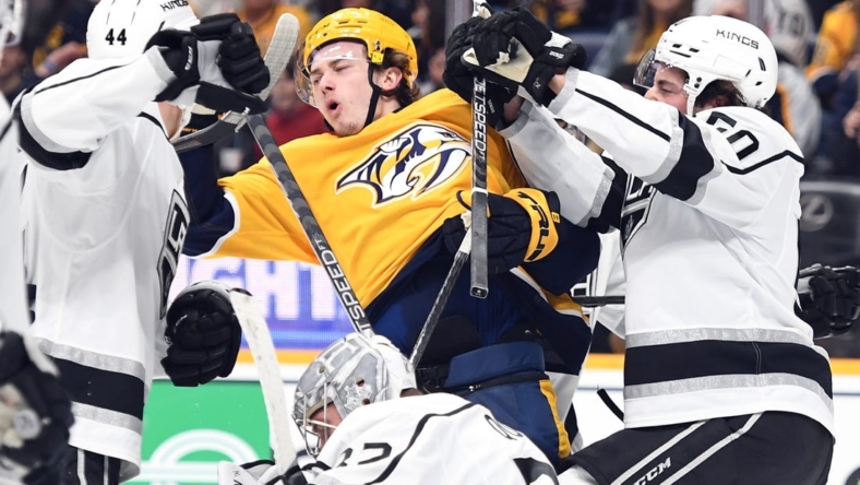 Jan 21, 2023; Nashville, Tennessee, USA; Nashville Predators center Cody Glass (8) is hit by Los Angeles Kings defenseman Sean Durzi (50) after the whistle during the first period at Bridgestone Arena. Mandatory Credit: Christopher Hanewinckel-USA TODAY Sports