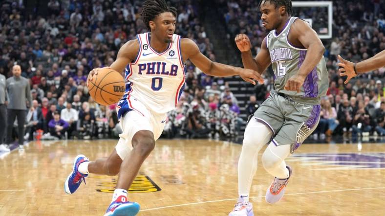 Jan 21, 2023; Sacramento, California, USA; Philadelphia 76ers guard Tyrese Maxey (0) dribbles against Sacramento Kings guard Davion Mitchell (15) during the first quarter at Golden 1 Center. Mandatory Credit: Darren Yamashita-USA TODAY Sports