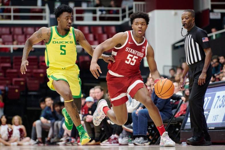 Jan 21, 2023; Stanford, California, USA; Stanford Cardinal forward Harrison Ingram (55) dribbles against Oregon Ducks guard Jermaine Couisnard (5) during the first half at Maples Pavilion. Mandatory Credit: Robert Edwards-USA TODAY Sports