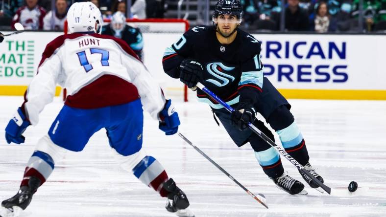 Jan 21, 2023; Seattle, Washington, USA; Seattle Kraken center Matty Beniers (10) skates with the puck against the Colorado Avalanche during the third period at Climate Pledge Arena. Mandatory Credit: Joe Nicholson-USA TODAY Sports