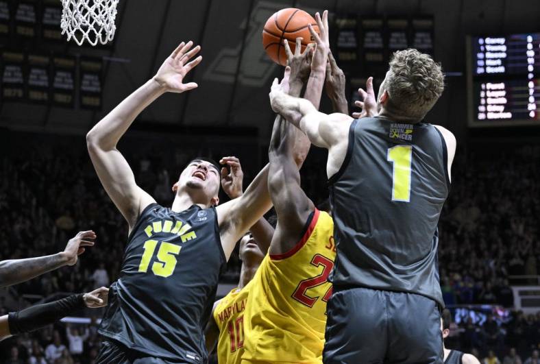 9Jan 22, 2023; West Lafayette, Indiana, USA;  Purdue Boilermakers center Zach Edey (15) and forward Caleb Furst (1) fights for a rebound against Maryland Terrapins forward Donta Scott (24) during the second half at Mackey Arena. Mandatory Credit: Marc Lebryk-USA TODAY Sports