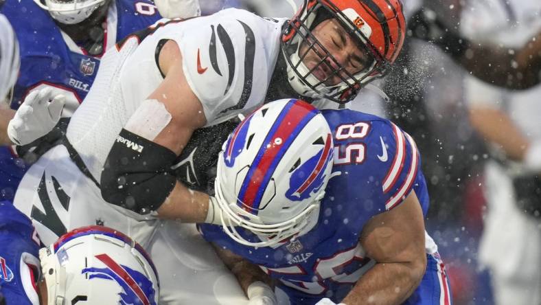 Jan 22, 2023; Orchard Park, New York, USA; Cincinnati Bengals tight end Mitchell Wilcox (84) collides with Buffalo Bills linebacker Matt Milano (58) after a catch in the second quarter of the NFL divisional playoff football game between the Cincinnati Bengals and the Buffalo Bills during an AFC divisional round game at Highmark Stadium. Mandatory Credit: Sam Greene-USA TODAY Sports