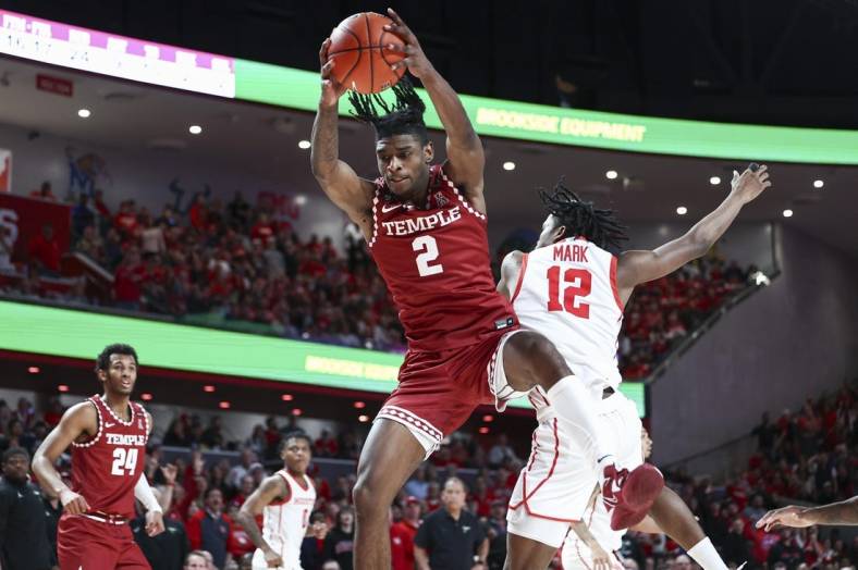 Jan 22, 2023; Houston, Texas, USA; Temple Owls guard Jahlil White (2) grabs a rebound away from Houston Cougars guard Tramon Mark (12) during the second half at Fertitta Center. Mandatory Credit: Troy Taormina-USA TODAY Sports