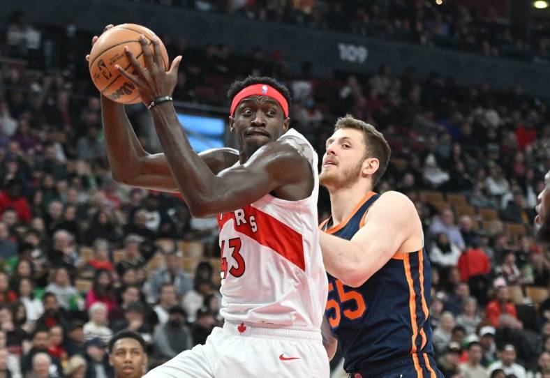 Jan 22, 2023; Toronto, Ontario, CAN;  Toronto Raptors forward Pascal Siakam (43) takes in a rebound beside New York Knicks center Isaiah Hartenstein (55) in the first half at Scotiabank Arena. Mandatory Credit: Dan Hamilton-USA TODAY Sports