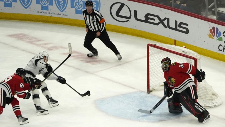 Jan 22, 2023; Chicago, Illinois, USA; Los Angeles Kings center Jaret Anderson-Dolan (28) shoots and scores a goal on Chicago Blackhawks goaltender Petr Mrazek (34) during the first period at United Center. Mandatory Credit: David Banks-USA TODAY Sports