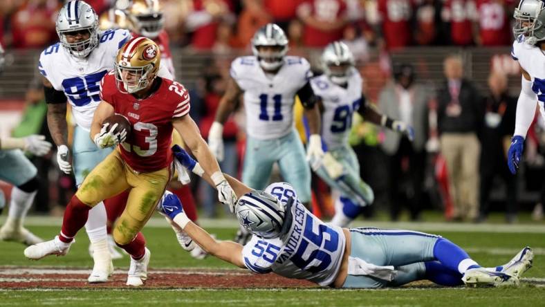 Jan 22, 2023; Santa Clara, California, USA; San Francisco 49ers running back Christian McCaffrey (23) runs past Dallas Cowboys linebacker Leighton Vander Esch (55) during the third quarter of a NFC divisional round game at Levi's Stadium. Mandatory Credit: Kyle Terada-USA TODAY Sports