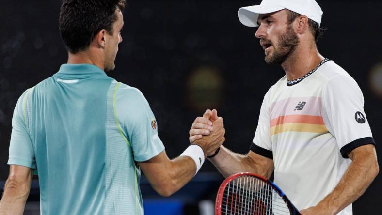 Jan 23, 2023; Melbourne, Victoria, Australia; Tommy Paul of the United States shakes hands with Roberto Bautista-Agut of Spain after beating him on day eight of the 2023 Australian Open tennis tournament at Melbourne Park. Mandatory Credit: Mike Frey-USA TODAY Sports