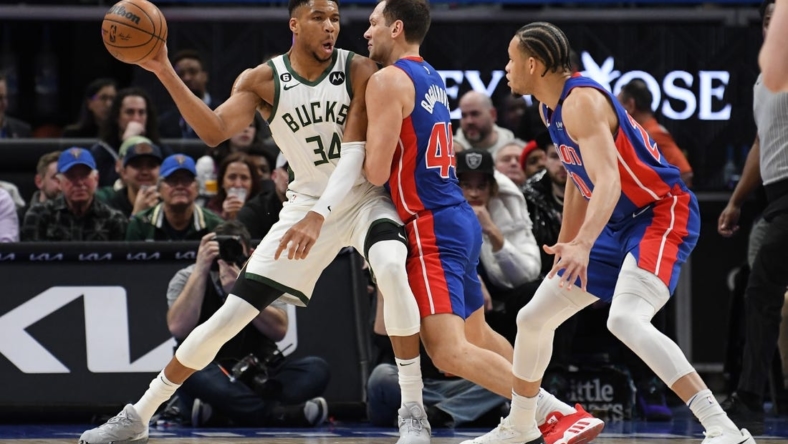 Jan 23, 2023; Detroit, Michigan, USA; Milwaukee Bucks forward Giannis Antetokounmpo (34) looks to pass the ball while being pressured by Detroit Pistons forward Bojan Bogdanovic (44) in the first quarter at Little Caesars Arena. Mandatory Credit: Lon Horwedel-USA TODAY Sports
