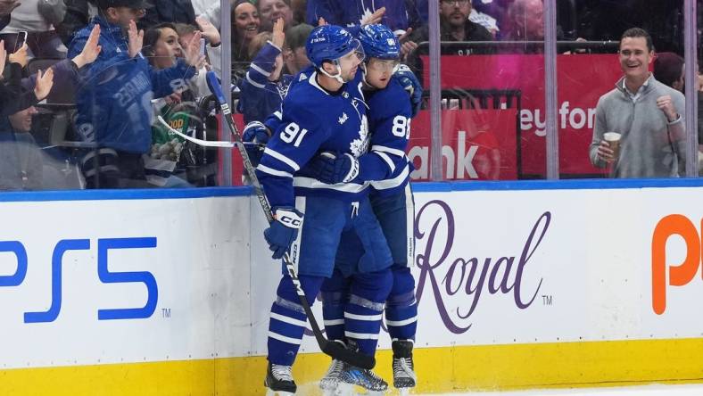 Jan 23, 2023; Toronto, Ontario, CAN; Toronto Maple Leafs right wing William Nylander (88) celebrates with Toronto Maple Leafs center John Tavares (91) after scoring a goal against the New York Islanders during the second period at Scotiabank Arena. Mandatory Credit: Nick Turchiaro-USA TODAY Sports