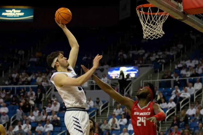 Nevada center Will Baker shoots over New Mexico forward Morris Udeze  in the first half of an NCAA college basketball game in Reno, Nev., Monday, Jan. 23, 2023. Tom R Smedes/Special to RGJ

New Mexico At Nevada Basketball 02