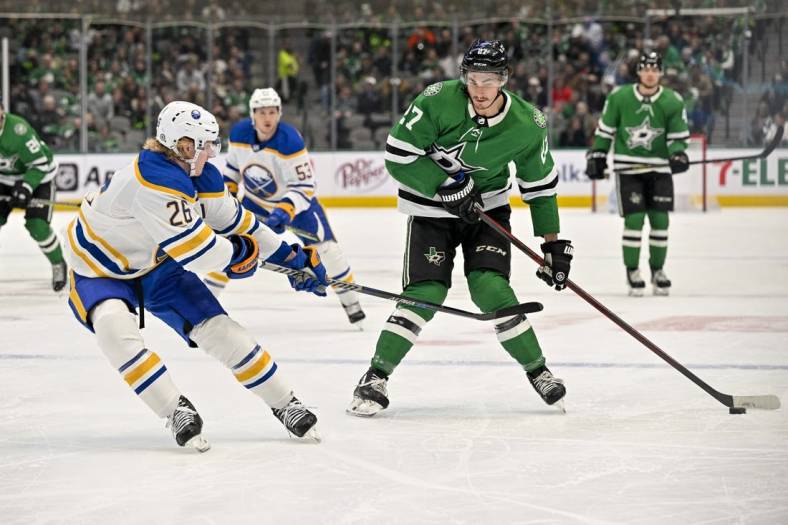 Jan 23, 2023; Dallas, Texas, USA; Buffalo Sabres defenseman Rasmus Dahlin (26) poke checks Dallas Stars left wing Mason Marchment (27) as he controls the puck in the Sabres zone during the second period at the American Airlines Center. Mandatory Credit: Jerome Miron-USA TODAY Sports