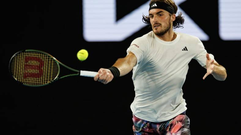 Jan 24, 2023; Melbourne, Victoria, Australia;  Stefanos Tsitsipas of Greece hits a shot against Jiri Lehecka of the Czech Republic on day nine of the 2023 Australian Open tennis tournament at Melbourne Park. Mandatory Credit: Mike Frey-USA TODAY Sports