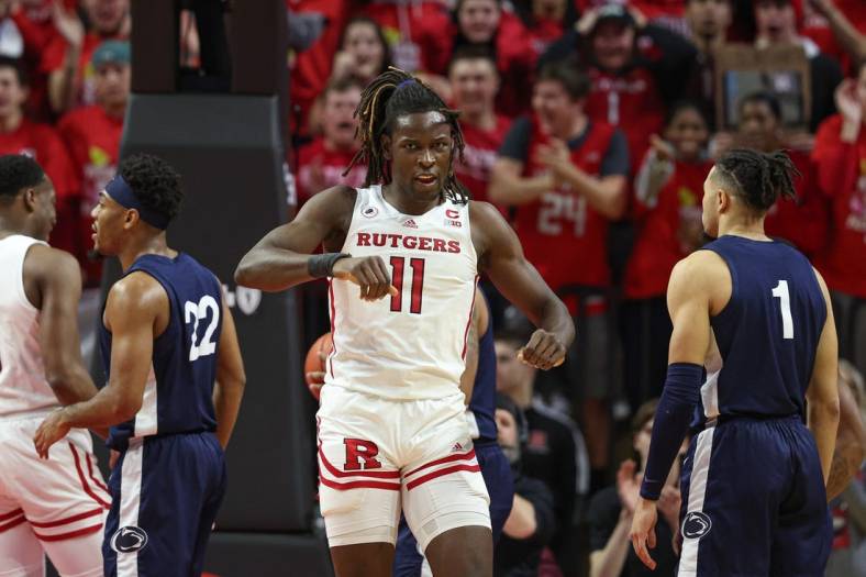 Jan 24, 2023; Piscataway, New Jersey, USA; Rutgers Scarlet Knights center Clifford Omoruyi (11) reacts after a basket during the first half in front of Penn State Nittany Lions guard Seth Lundy (1) at Jersey Mike's Arena. Mandatory Credit: Vincent Carchietta-USA TODAY Sports