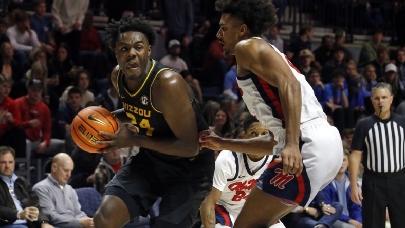 Jan 24, 2023; Oxford, Mississippi, USA; Missouri Tigers guard/forward Kobe Brown (24) drives to the basket as Mississippi Rebels forward Jaemyn Brakefield (4) defends during the first half at The Sandy and John Black Pavilion at Ole Miss. Mandatory Credit: Petre Thomas-USA TODAY Sports