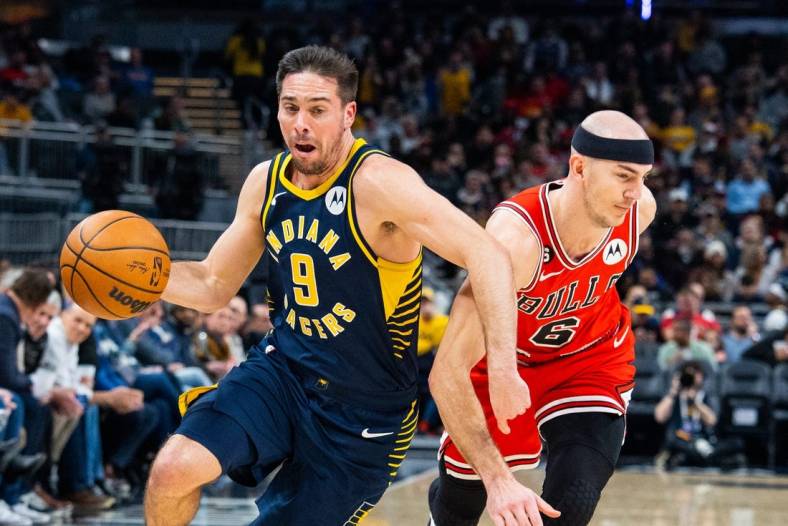 Jan 24, 2023; Indianapolis, Indiana, USA; Indiana Pacers guard T.J. McConnell (9) dribbles the ball while Chicago Bulls guard Alex Caruso (6) defends in the second quarter at Gainbridge Fieldhouse. Mandatory Credit: Trevor Ruszkowski-USA TODAY Sports