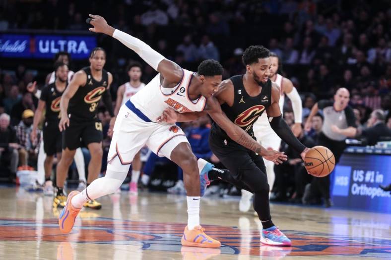 Jan 24, 2023; New York, New York, USA;  New York Knicks guard RJ Barrett (9) and Cleveland Cavaliers guard Donovan Mitchell (45) play for the ball in the first quarter at Madison Square Garden. Mandatory Credit: Wendell Cruz-USA TODAY Sports